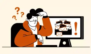 Hombre confundido frente a un monitor con muchos correos. Aprende cómo eliminar correos no deseados en Gmail y recupera tu tranquilidad.