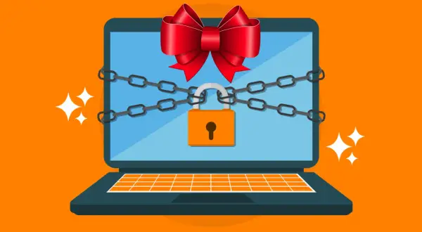 Un portátil con cadenas y un candado, adornado con un lazo rojo, simboliza la seguridad de Windows.