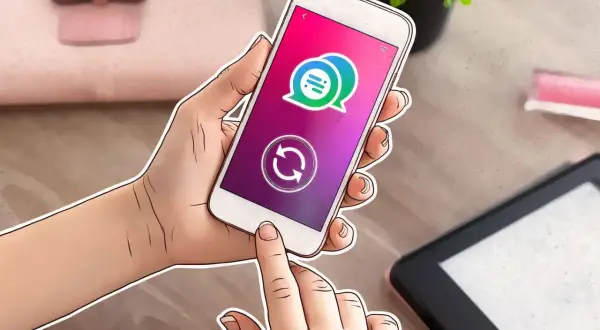 Mano sujetando un smartphone con un icono de chat y un símbolo de actualización, indicando cómo actualizar una app.