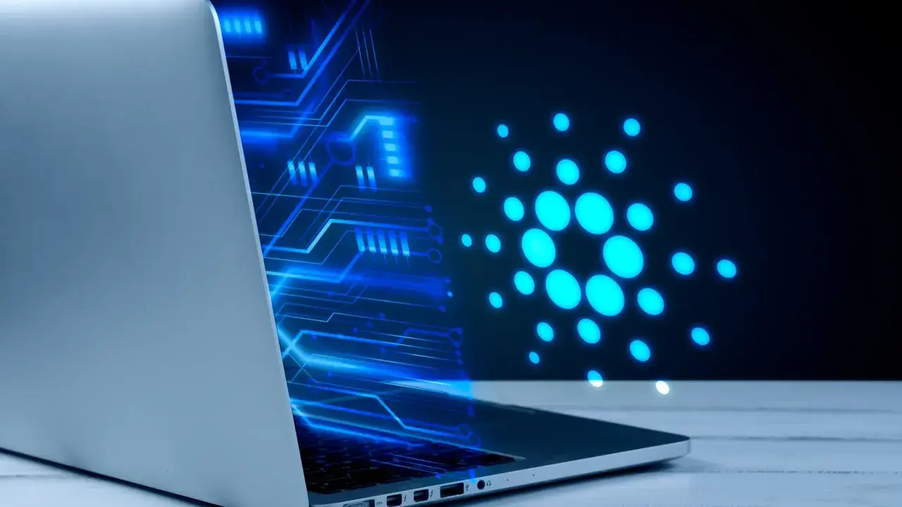 Un portátil muestra un diseño de circuito azul brillante y el logo de Cardano, ilustrando cómo funciona una máquina virtual en un entorno digital.