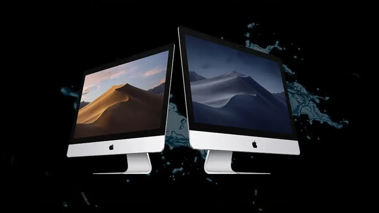 Dos iMacs con paisajes de dunas en sus pantallas, rodeados de salpicaduras de agua. Uno de ellos parece un iMac muy lento, con el agua cayendo.